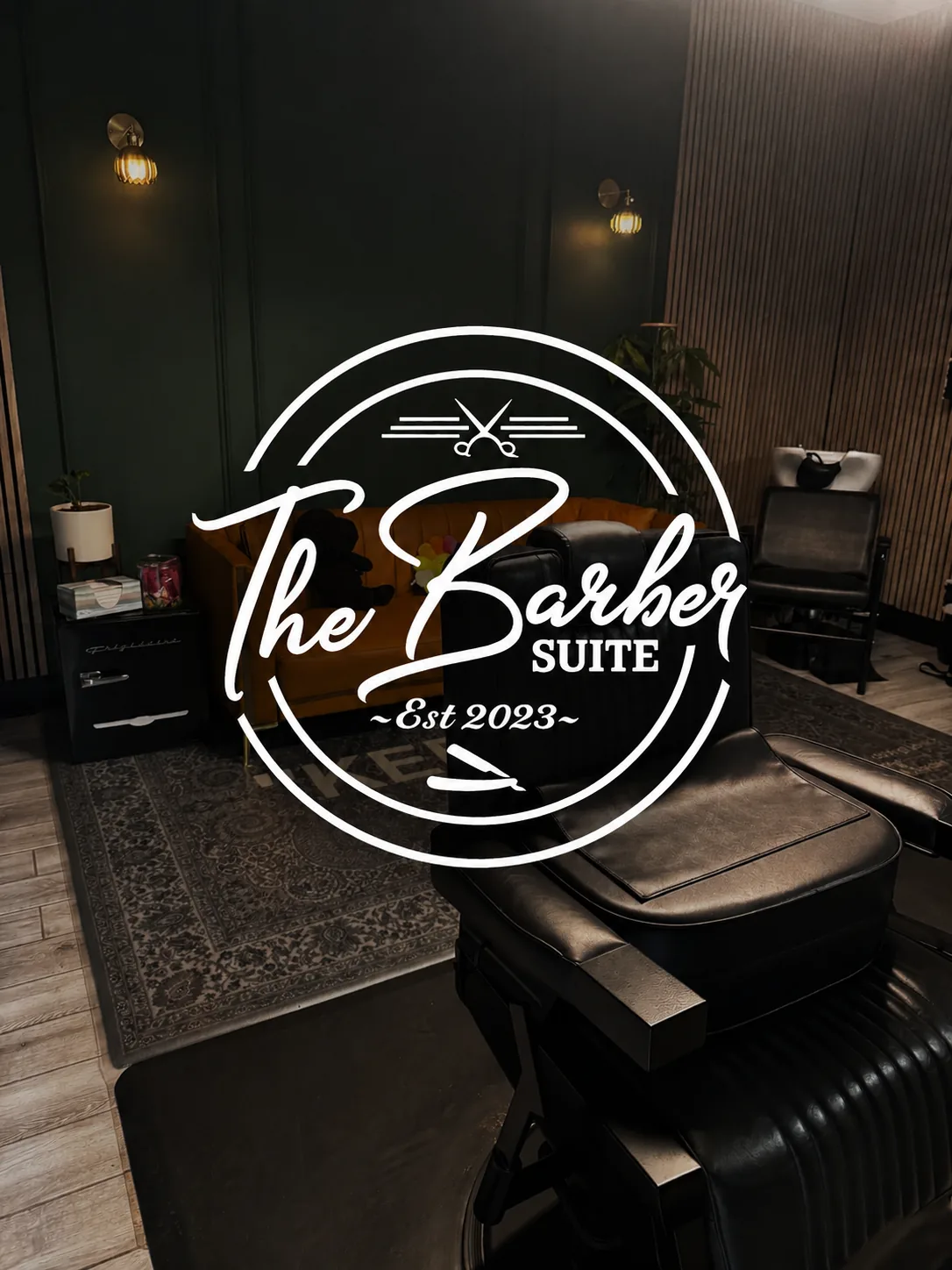 Interior of The Barber Suite with the studio logo, a premium men's grooming studio